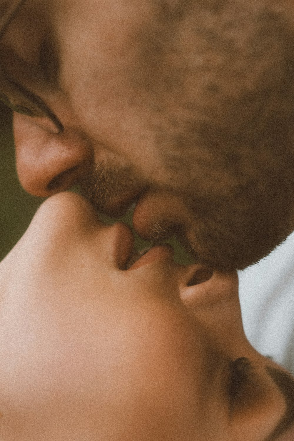 a close up of a person kissing another person