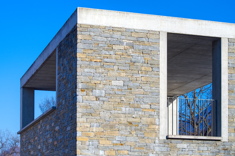 a brick building with a window and a balcony