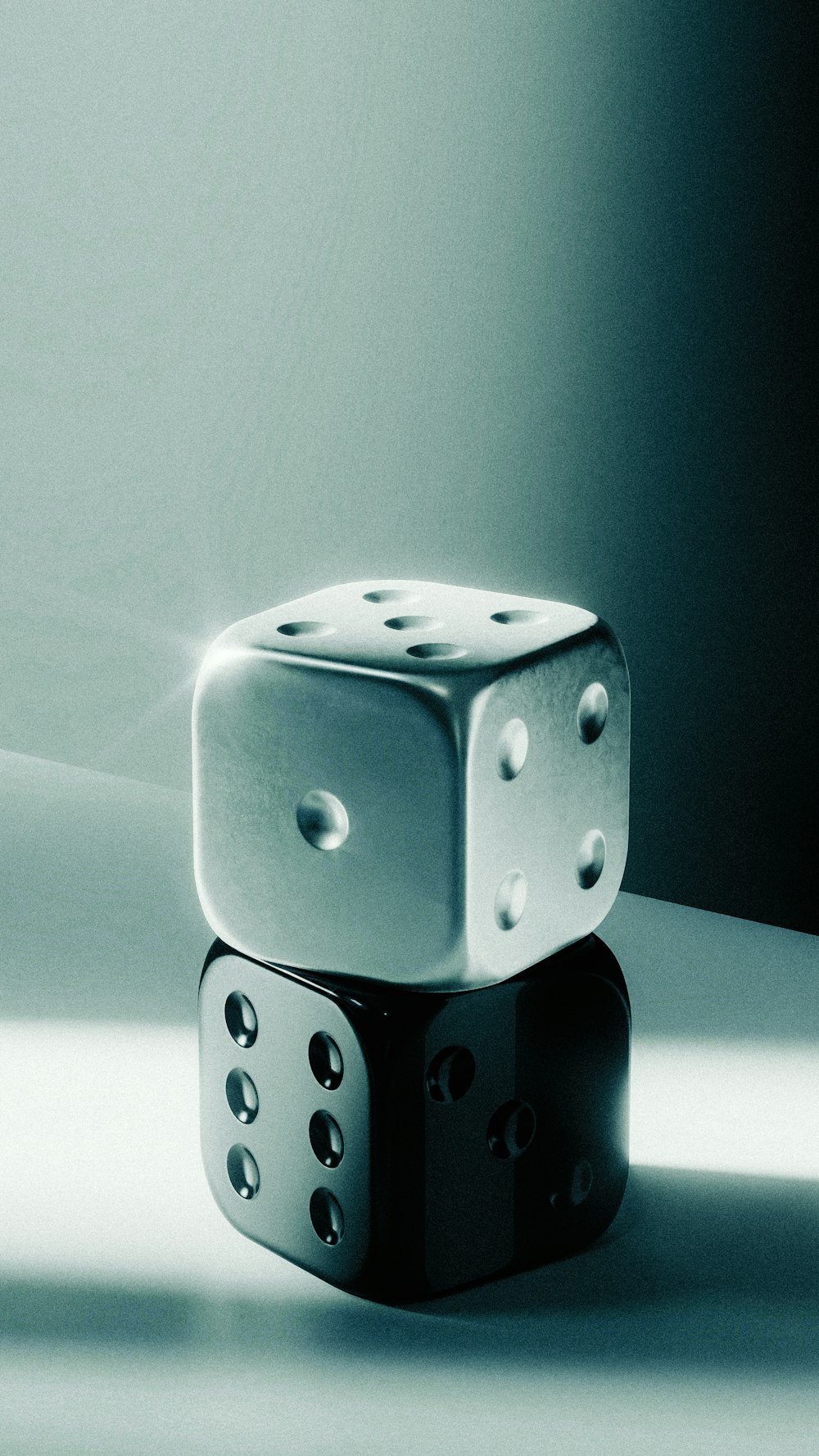 two dices sitting on top of each other on a table