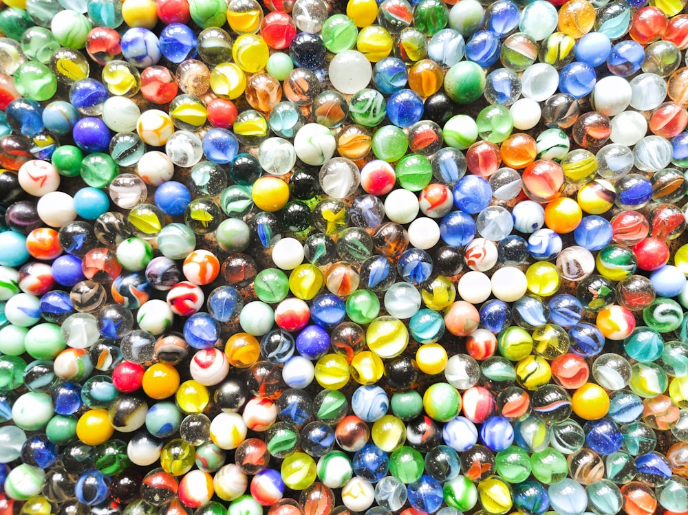 a bunch of marbles that are all different colors