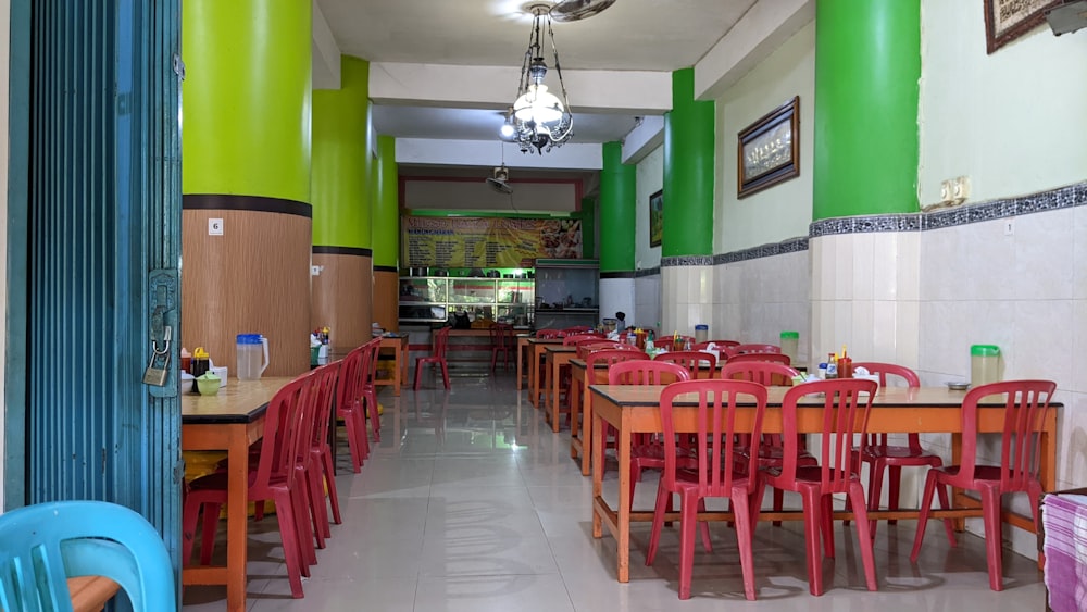 a restaurant with tables and chairs and a chandelier hanging from the ceiling