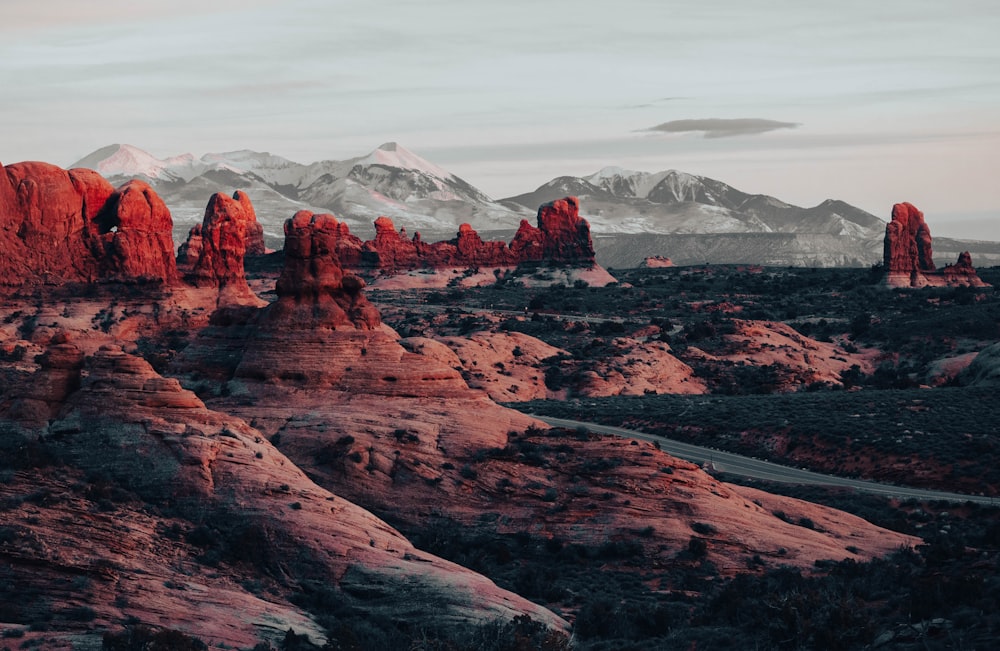 the mountains are covered in red rocks and snow