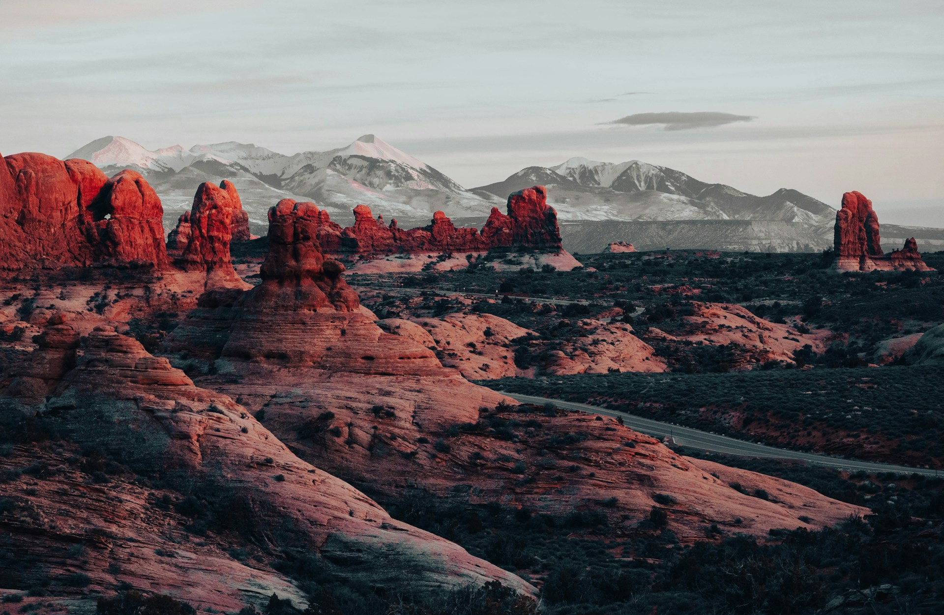 the mountains are covered in red rocks and snow
