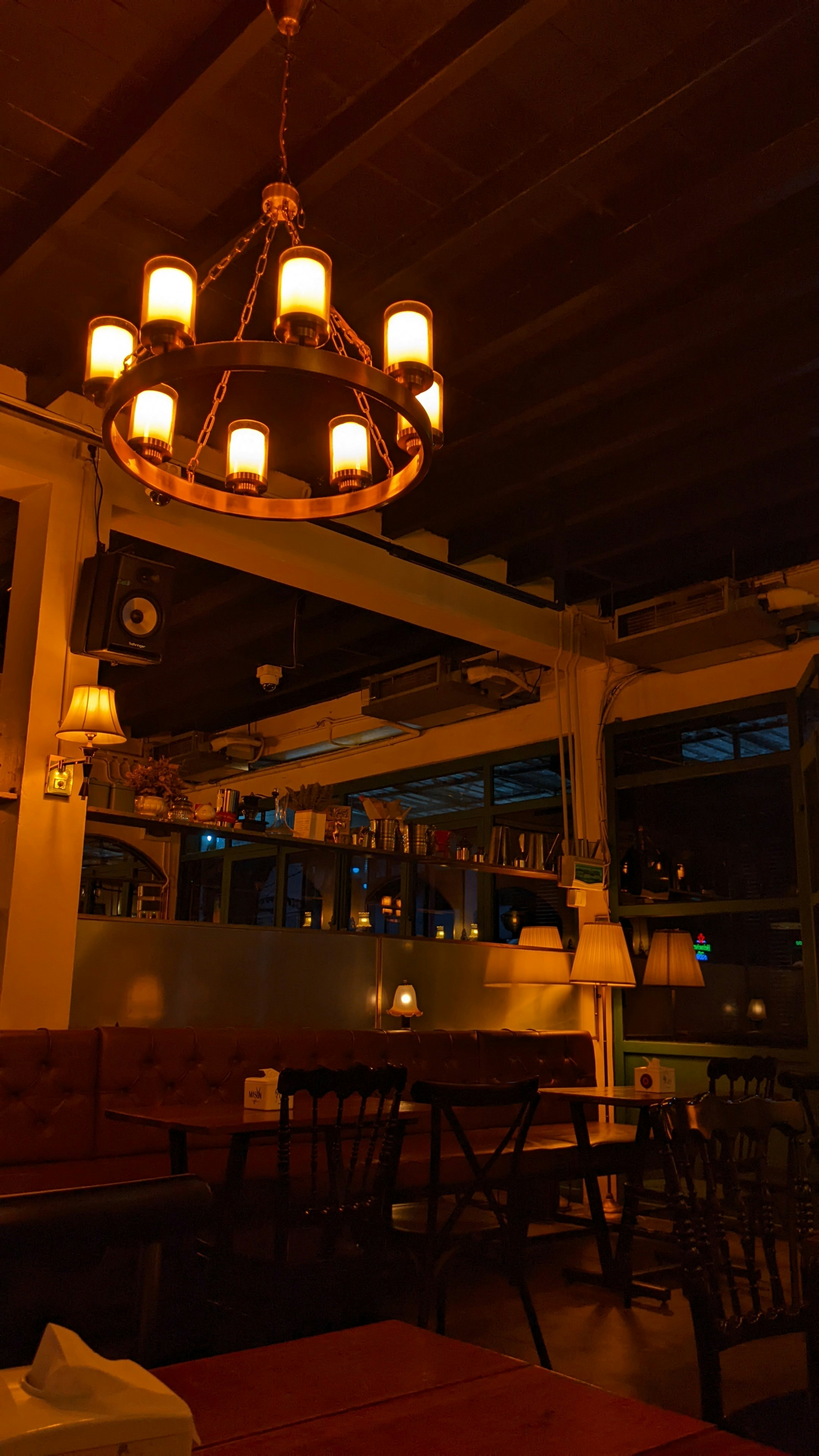 Upscale restaurant interior with warm candlelit atmosphere, rich textures, inviting golden light