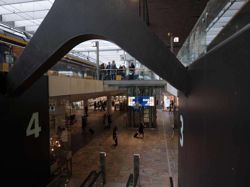 a group of people walking around a train station