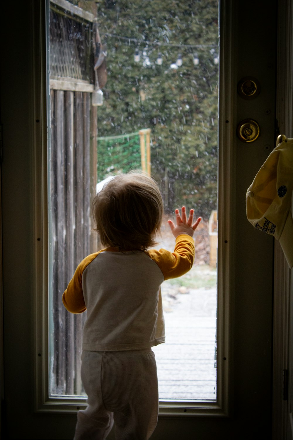 a small child standing in front of a door