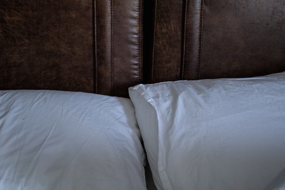 a close up of two pillows on a bed