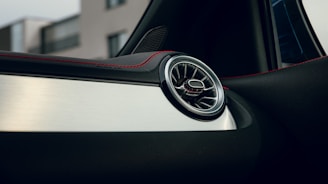 a close up of a car door handle with a building in the background