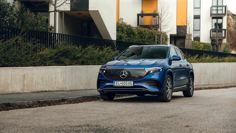 a blue car parked on the side of the road