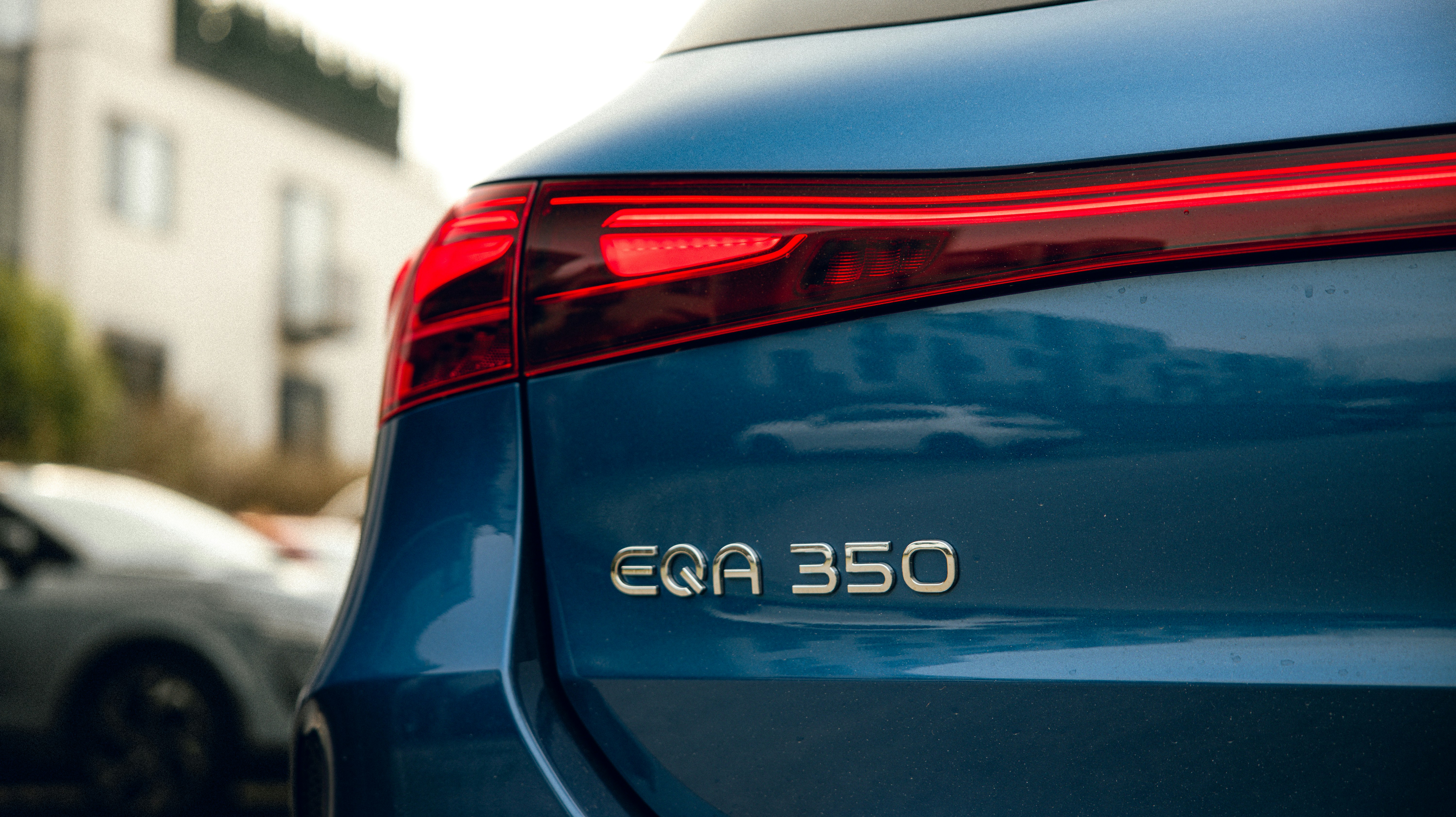 a close up of the rear end of a blue car