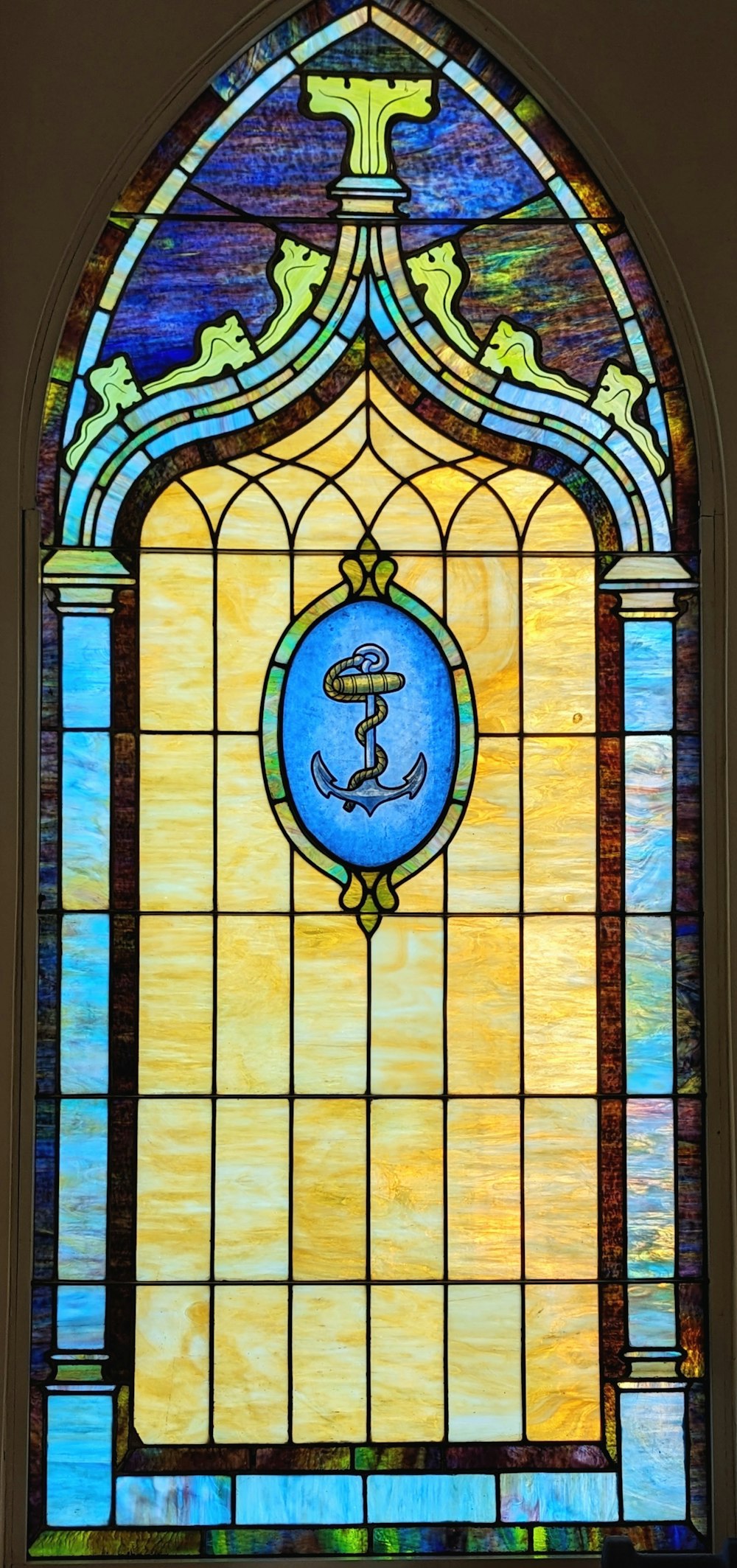 a stained glass window with an anchor on it