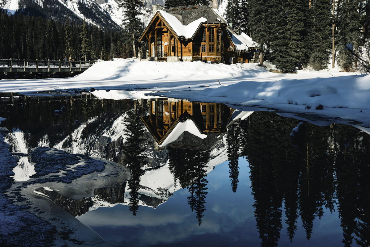 Lakeside cabin surrounded by mountains
