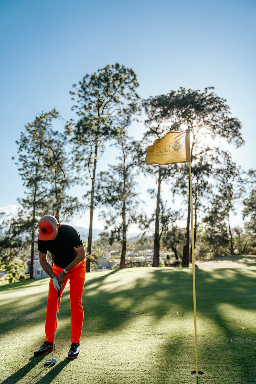 a man playing golf on a sunny day