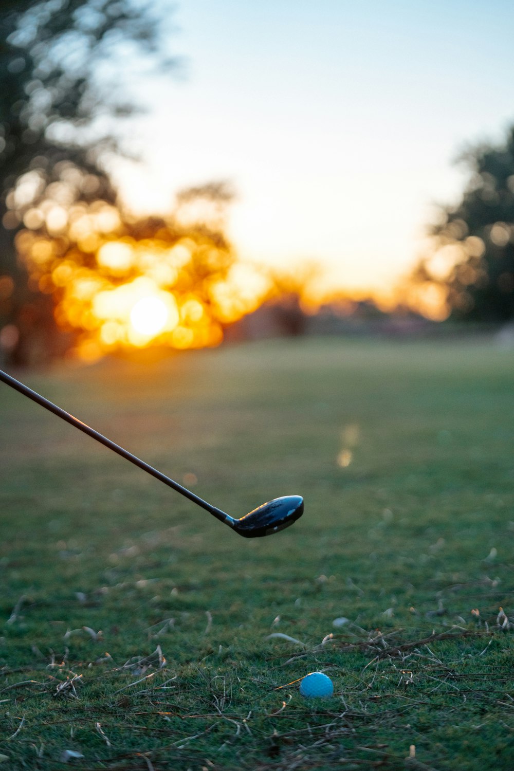 a person hitting a golf ball with a golf club