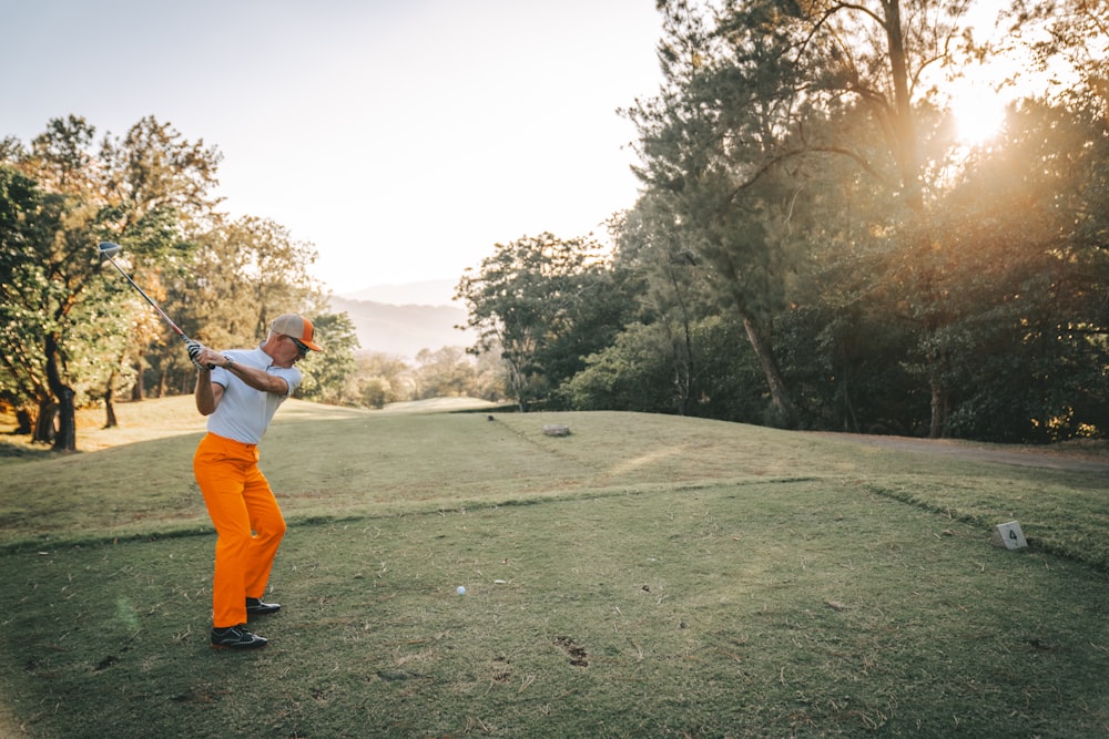 a man swinging a golf club on a golf course