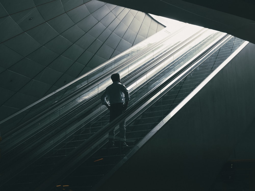 a man standing on an escalator in a building