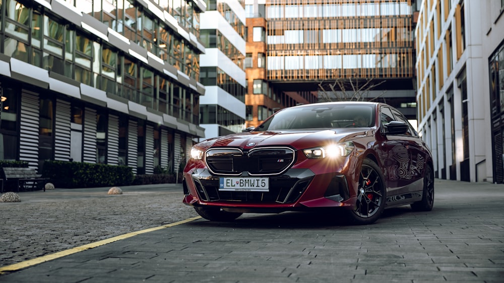 a red car parked in front of a tall building