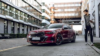 a man standing next to a red car