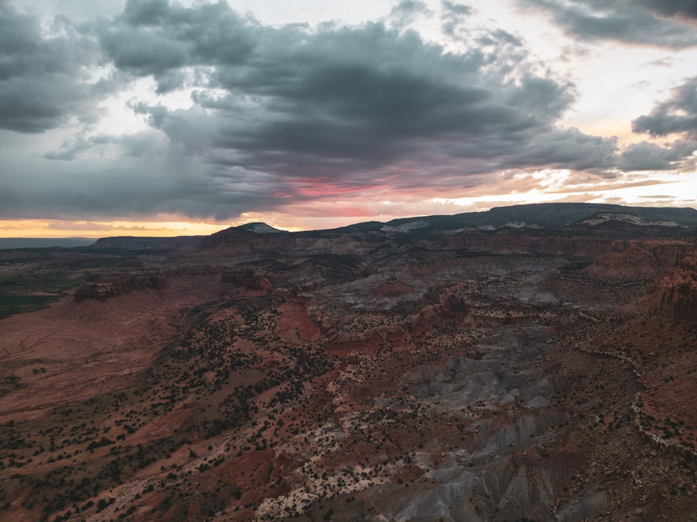 an aerial view of a mountain range at sunset