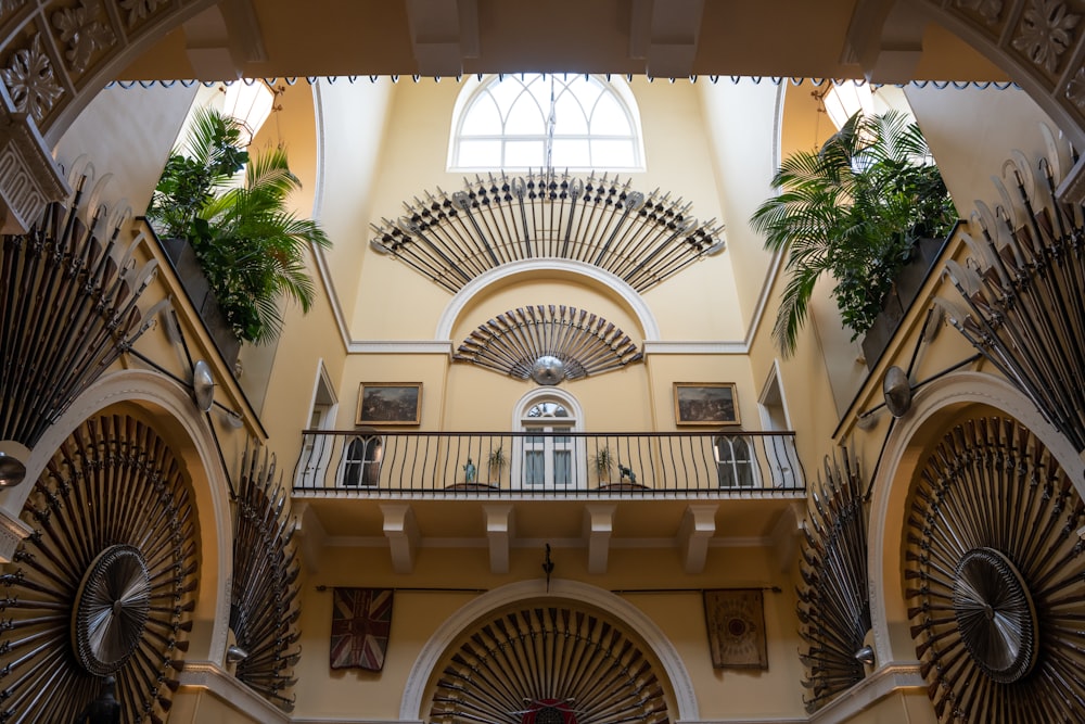 a large building with a bunch of plants on the balconies