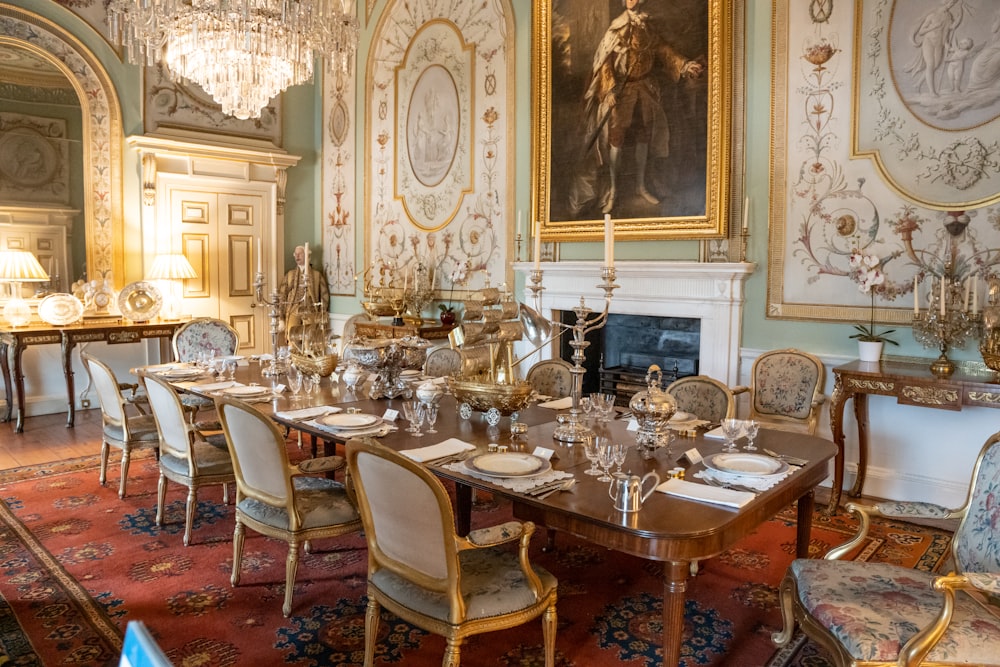 a fancy dining room with a fireplace and chandelier