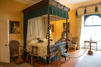 a bedroom with a canopy bed and a chair
