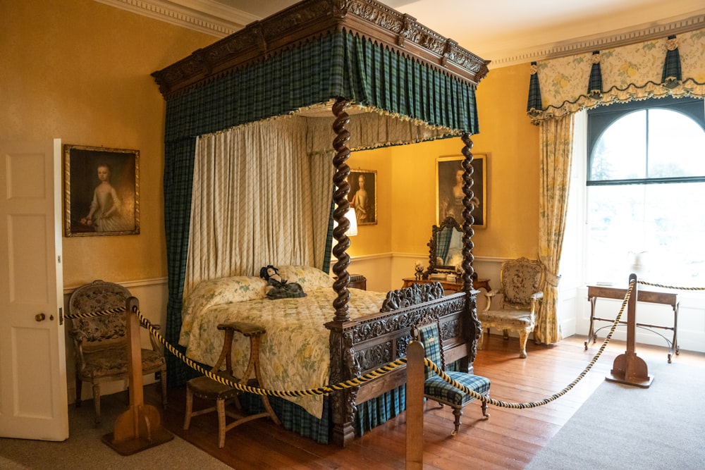 a bedroom with a canopy bed and a chair