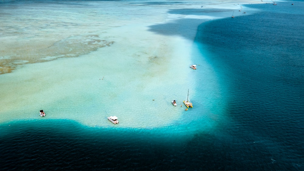 a group of boats floating on top of a body of water