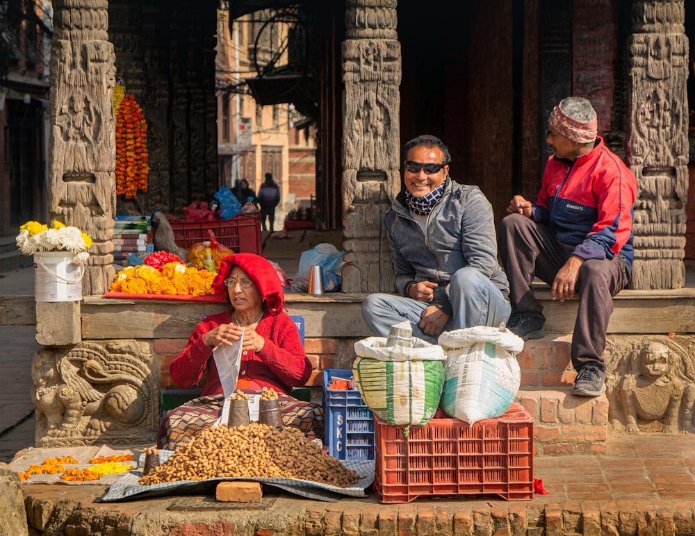 a man and a woman sitting on the steps of a building