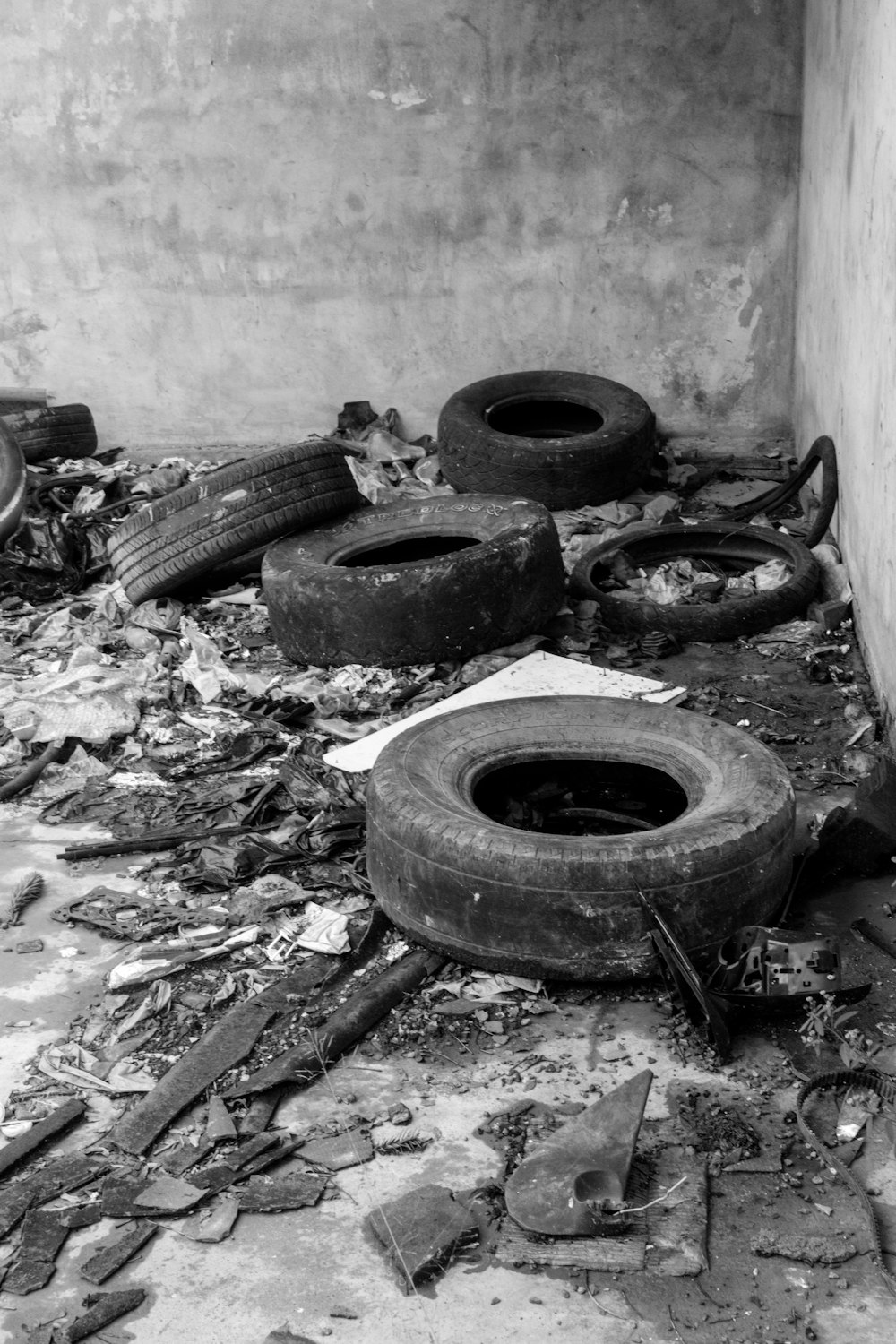 a black and white photo of a pile of old tires