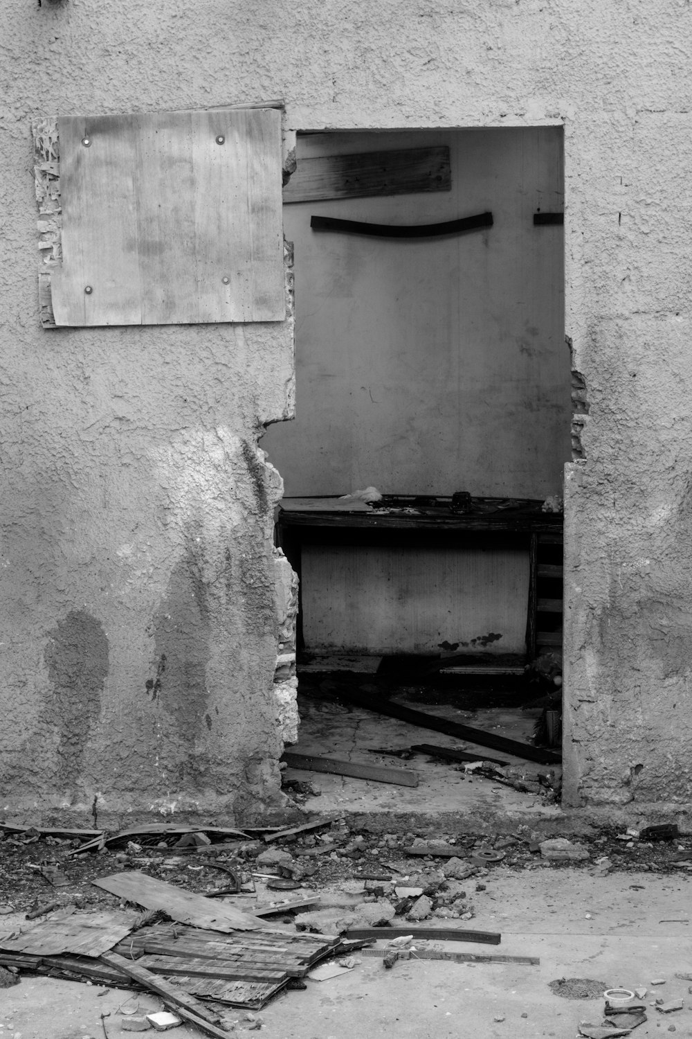 a black and white photo of a broken door