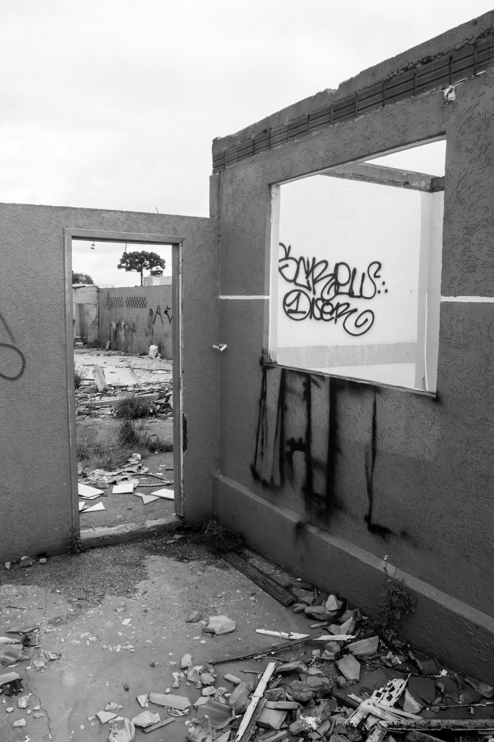 a black and white photo of graffiti on a wall