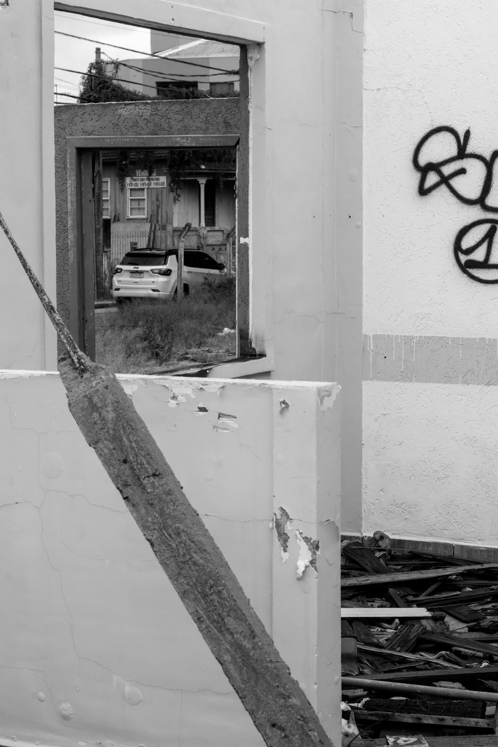 a black and white photo of a door with graffiti on it