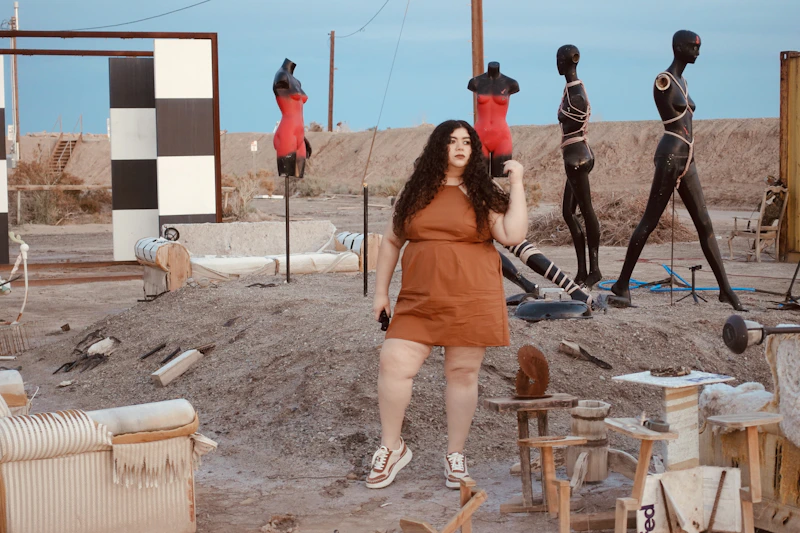 Fashionable BBW woman among mannequins