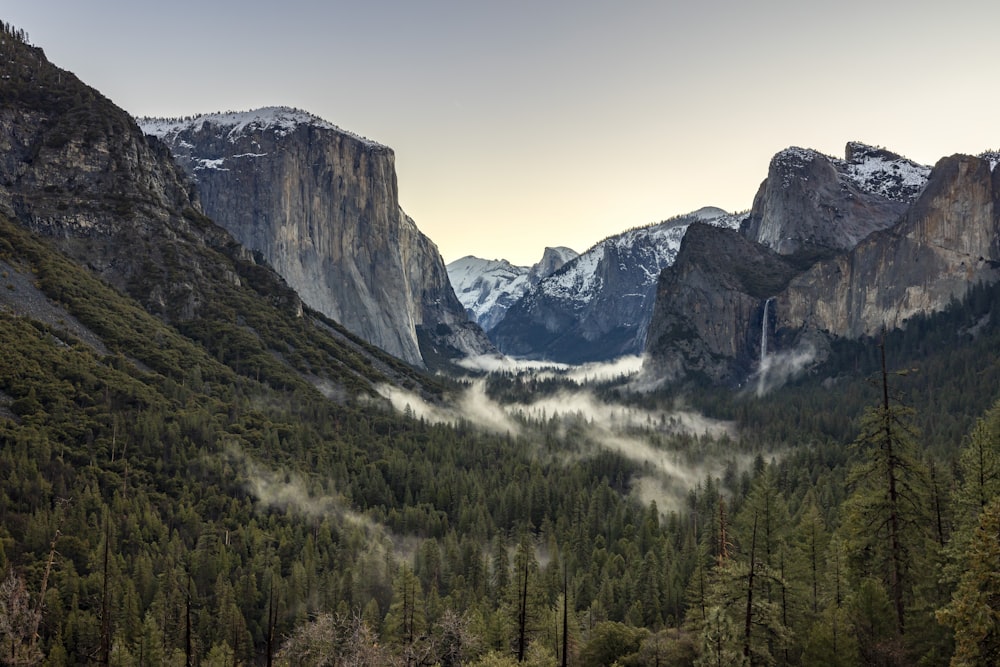 a view of a valley with mountains in the background