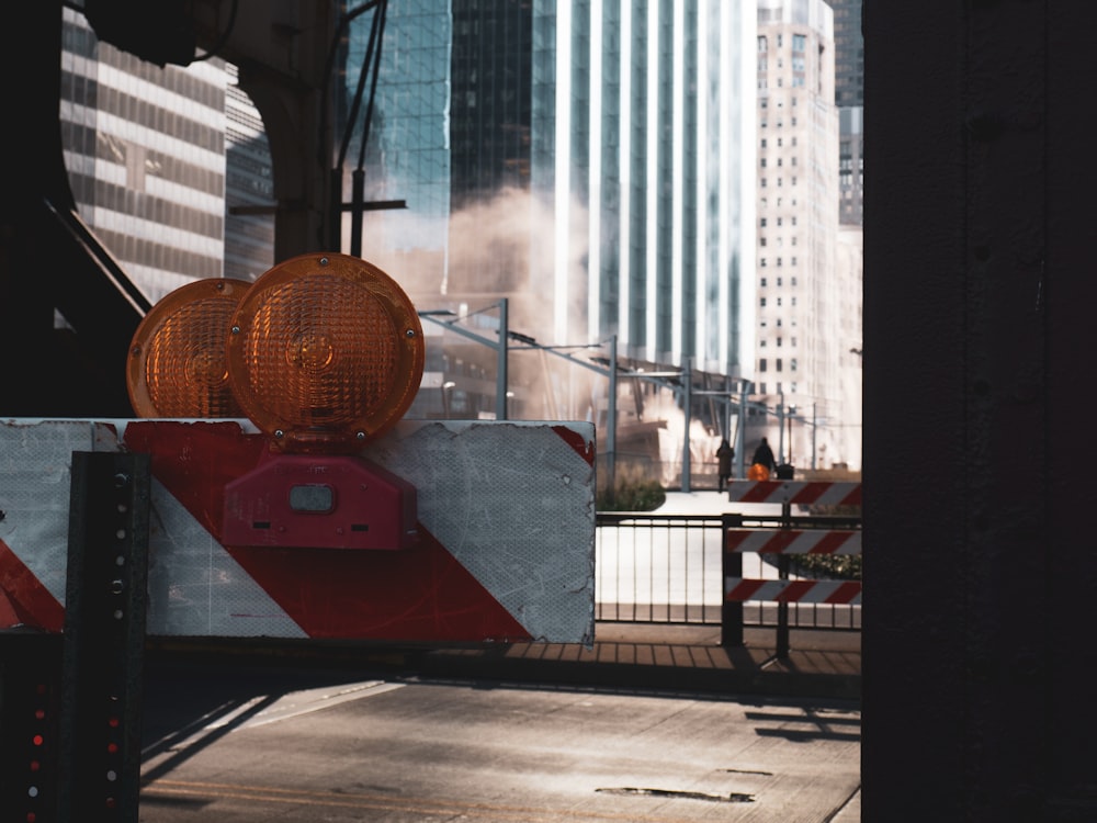 a red and white barricade on a city street