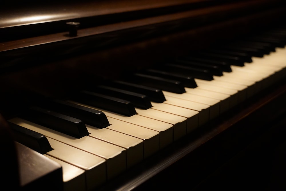 a close up of a piano keyboard in a dark room