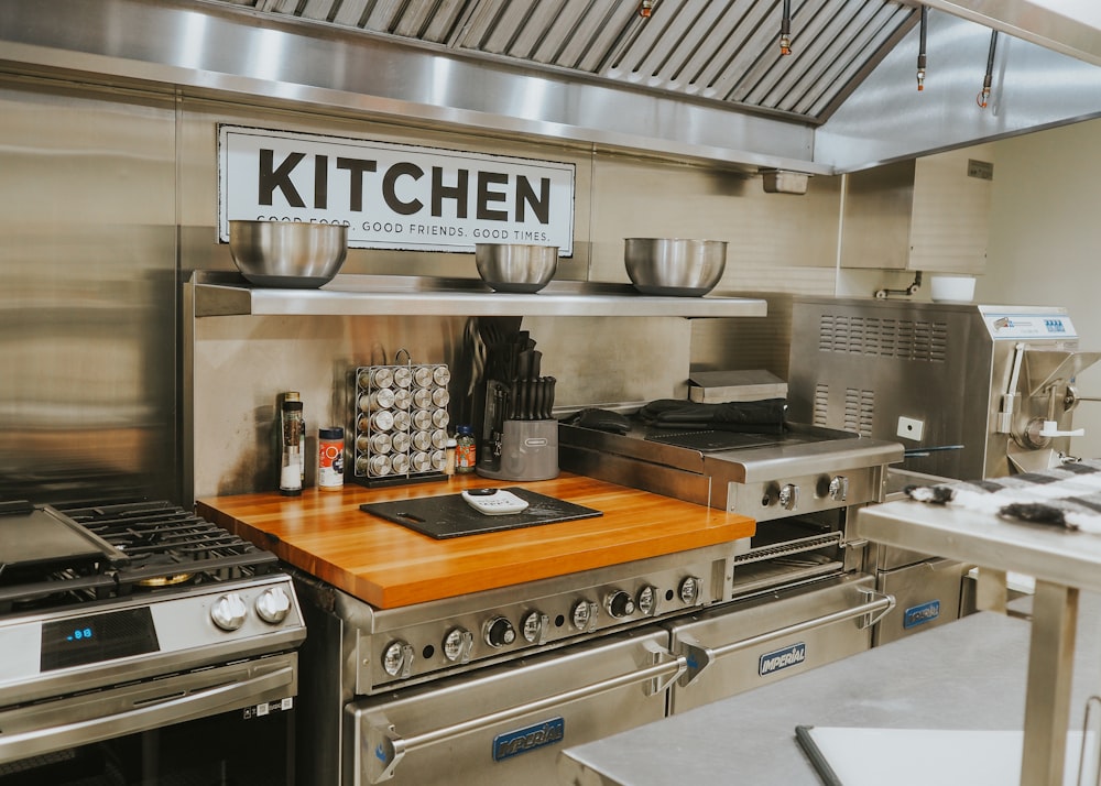 a kitchen with stainless steel appliances and a wooden counter