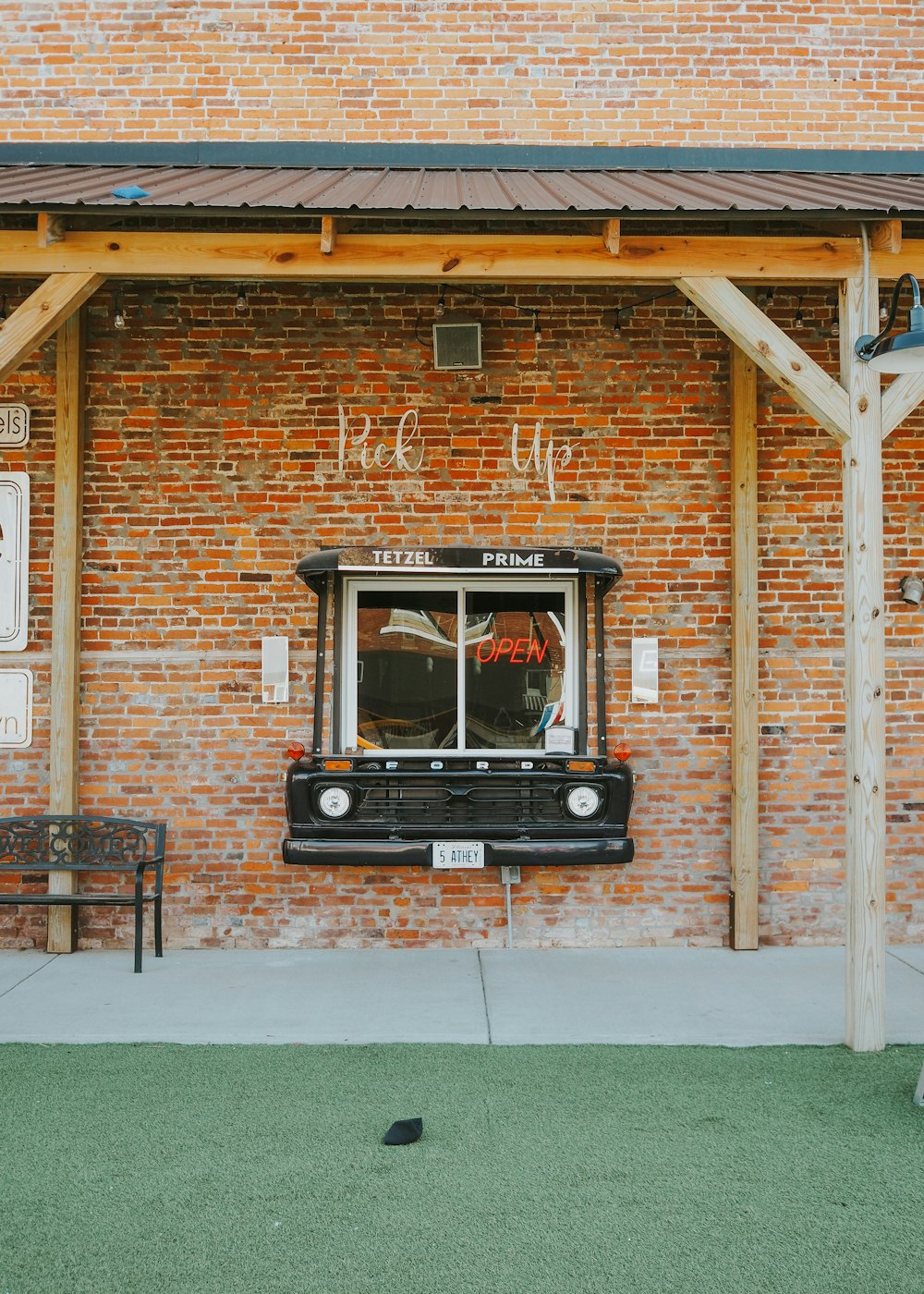 a black truck parked in front of a brick building