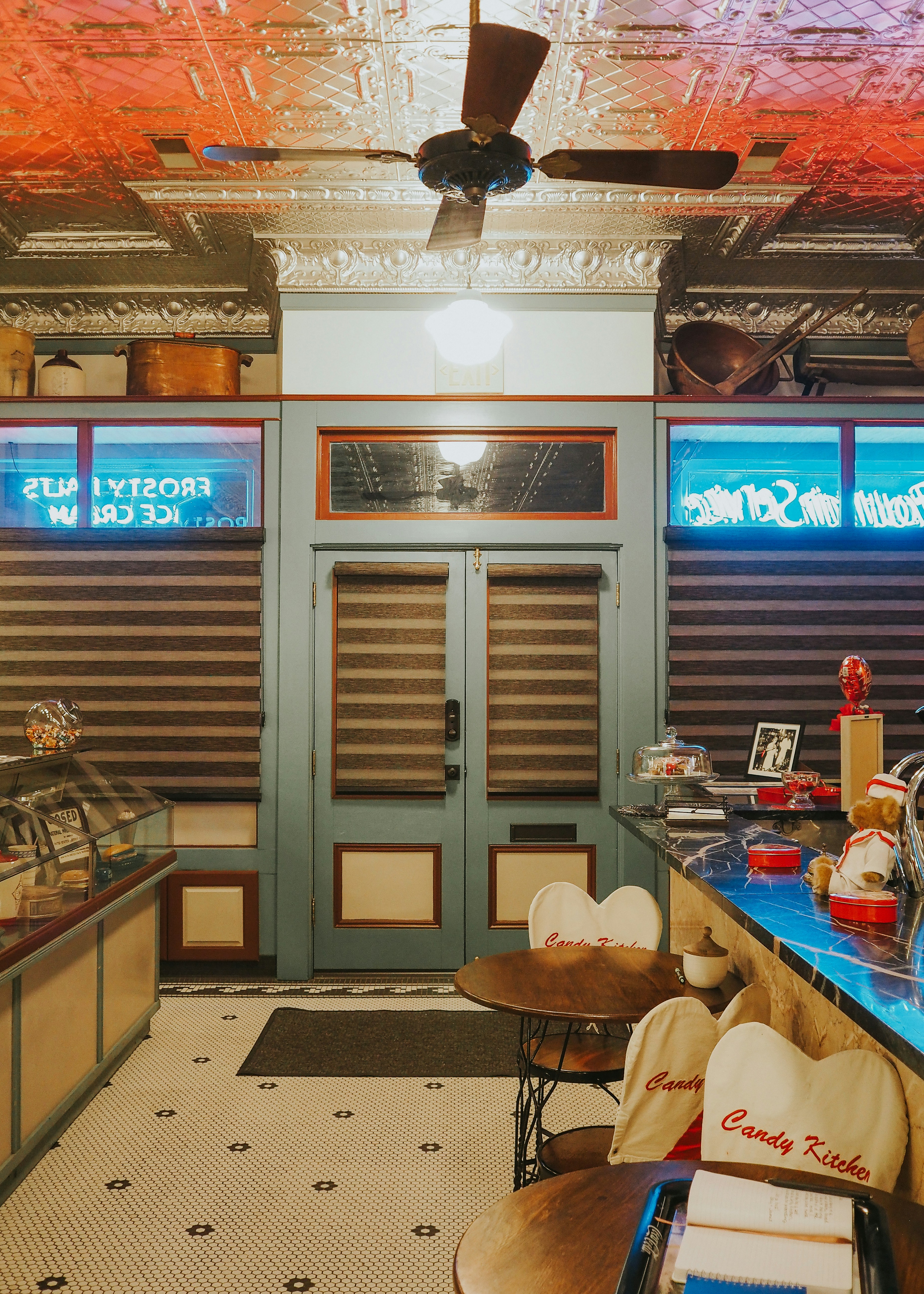 Vibrant neon-lit retro interior with colorful period-accurate production design elements