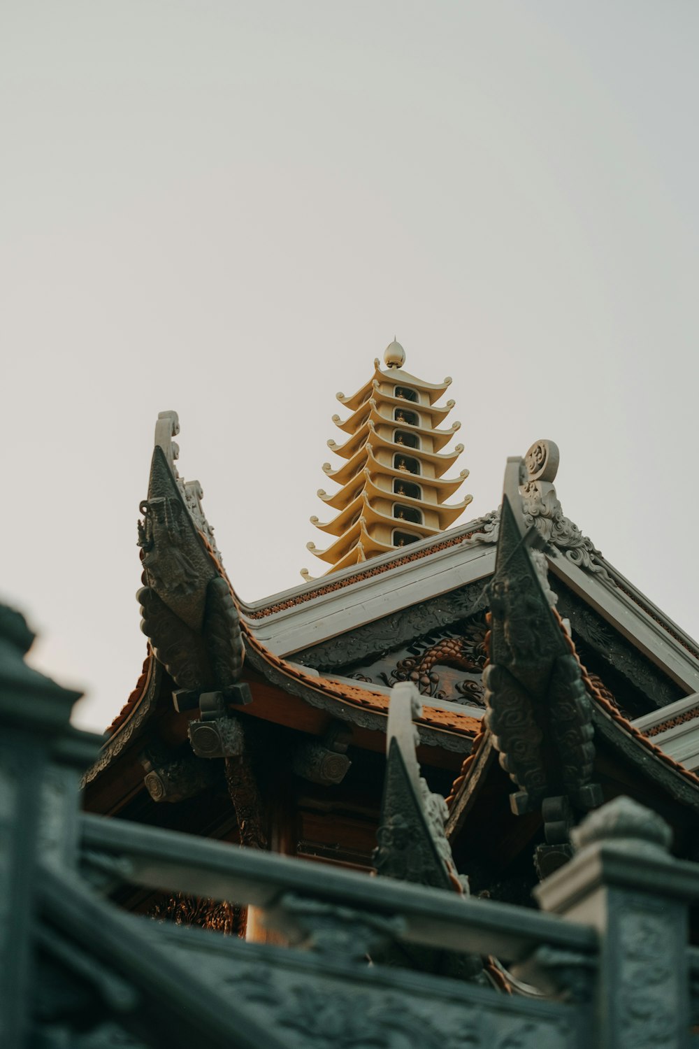 a tall building with a yellow roof and a tall tower