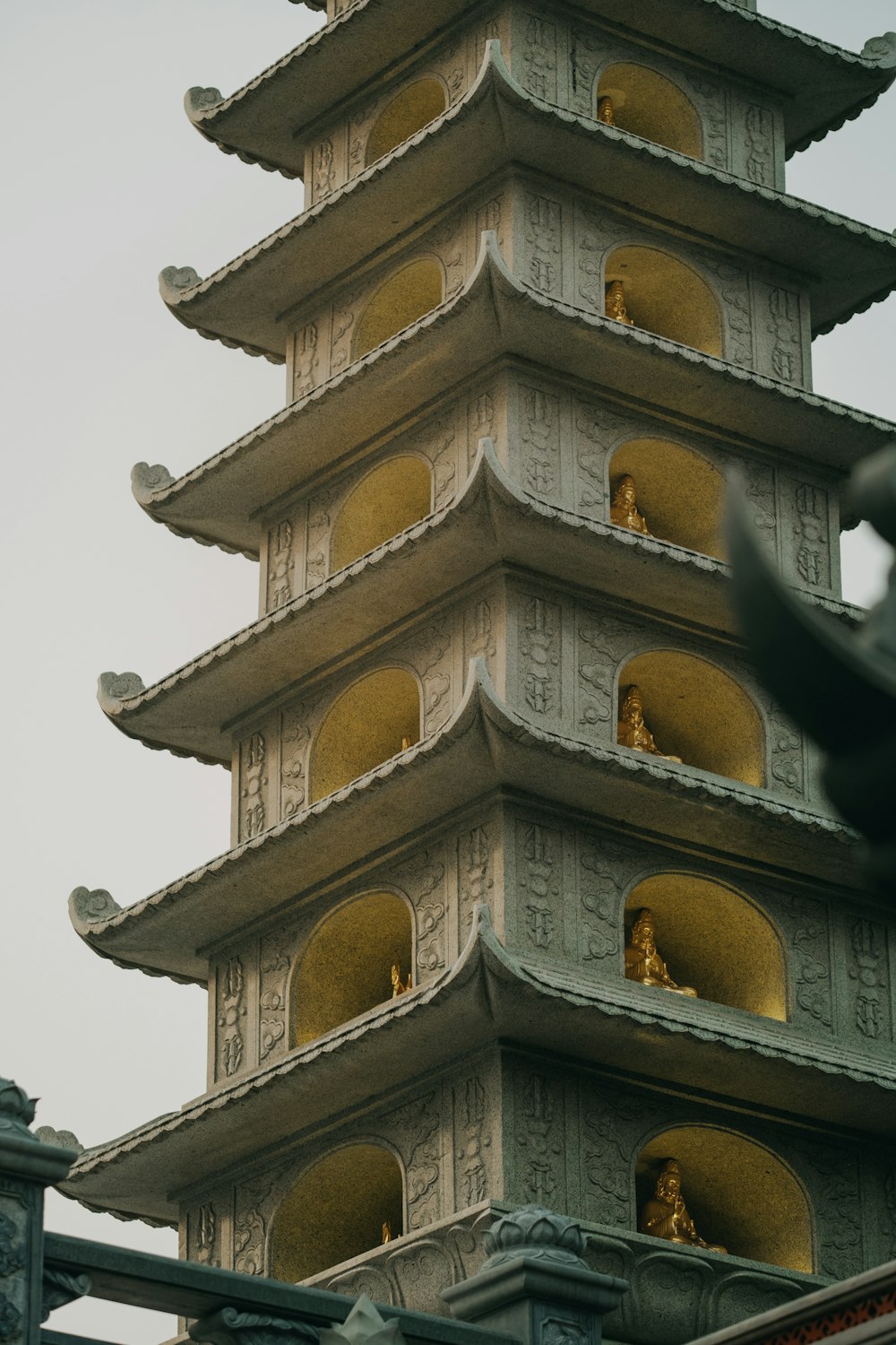 a tall tower with statues on top of it