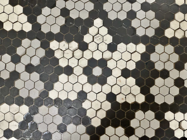 Black and white marble hexagon mosaic floor in a flower pattern