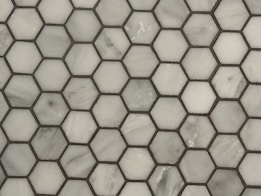 a close up of a white marble mosaic tile