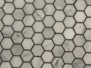 a close up of a white marble mosaic tile