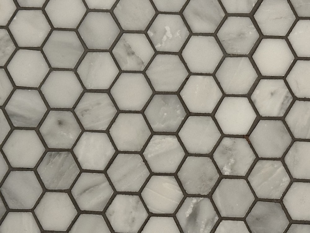 a close up of a white marble mosaic tile