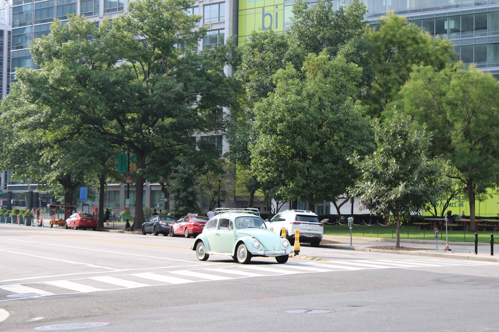 an old car is stopped at a crosswalk