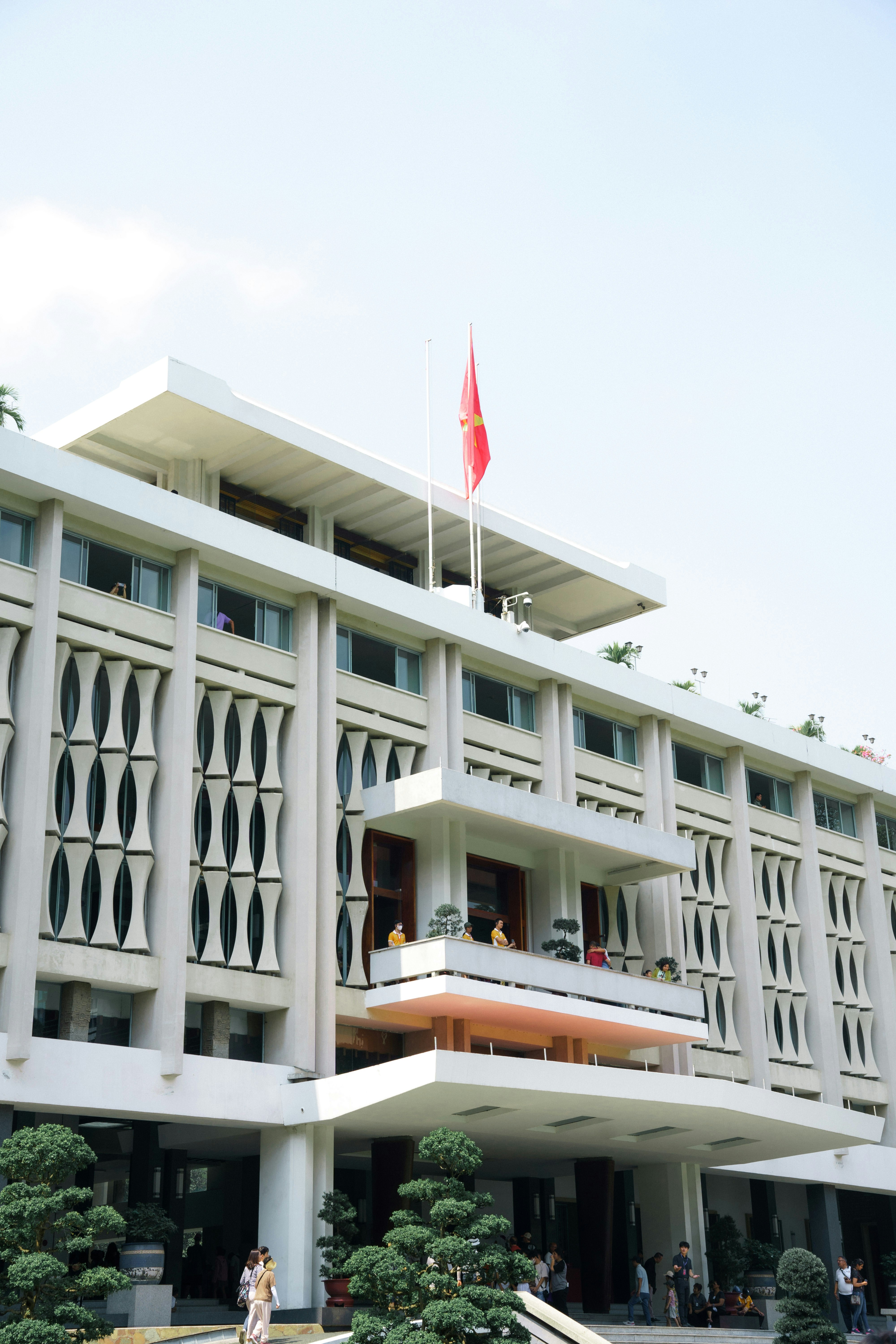 a large white building with a red flag on top of it