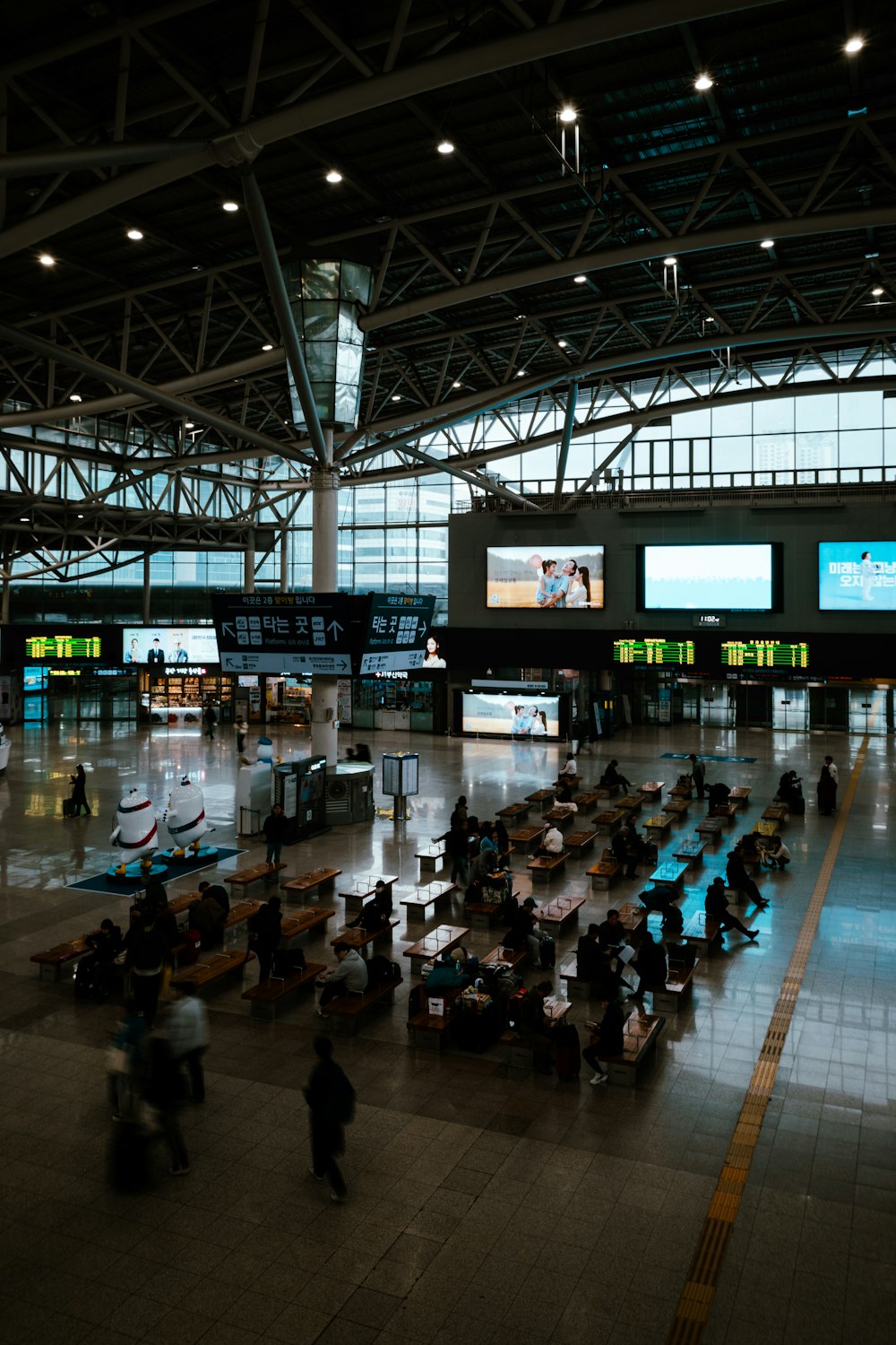 a group of people walking through an airport