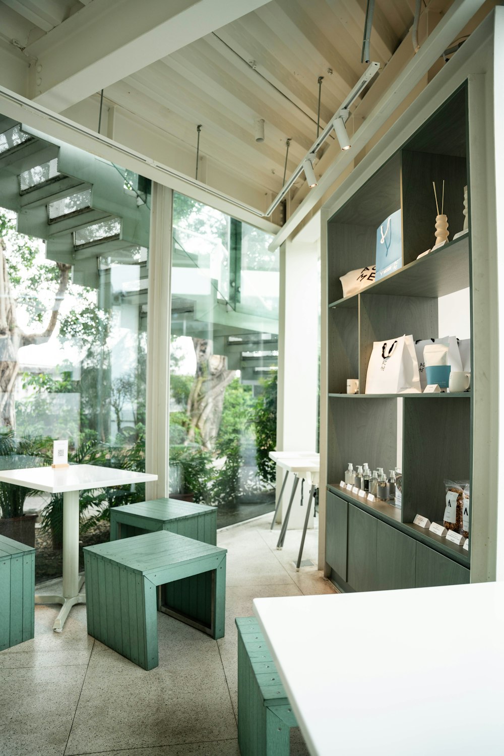 a room with a table, benches and shelves